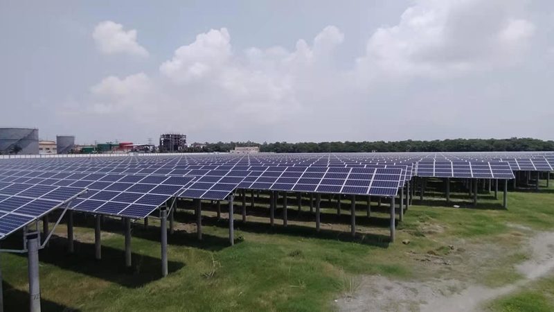 Technicians installing solar modules on a mounting structure